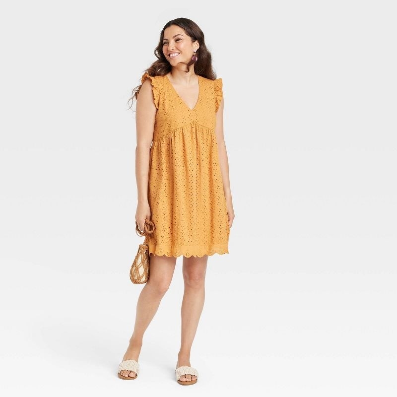 model wearing the dress in mustard