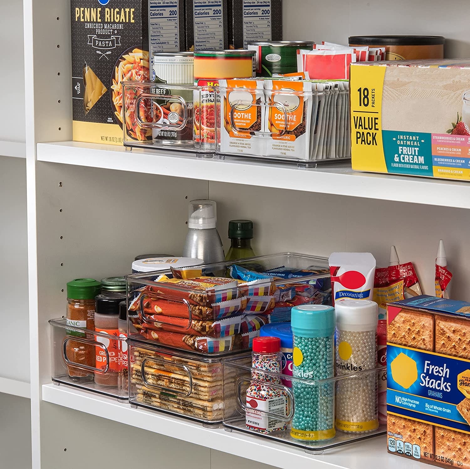 A cupboard with the organizer bins holding snacks