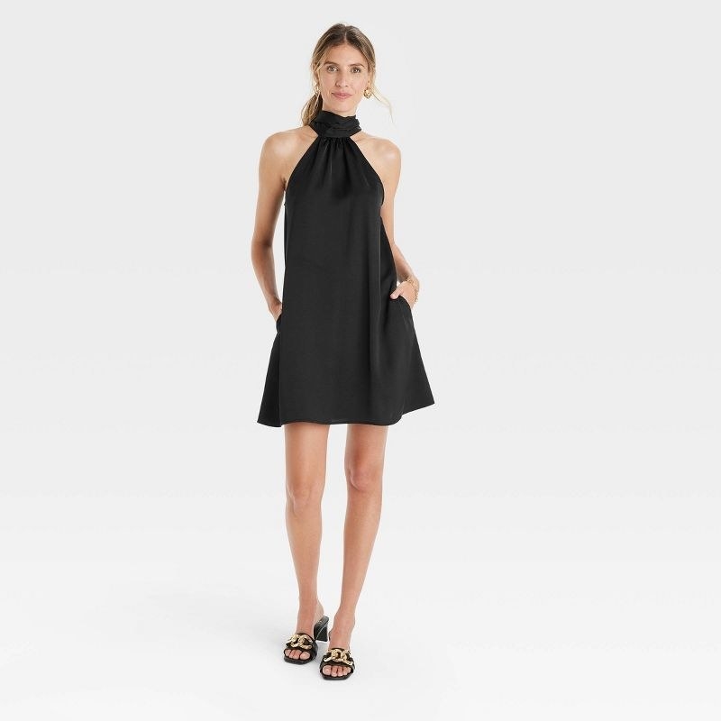 model wears the dress in black