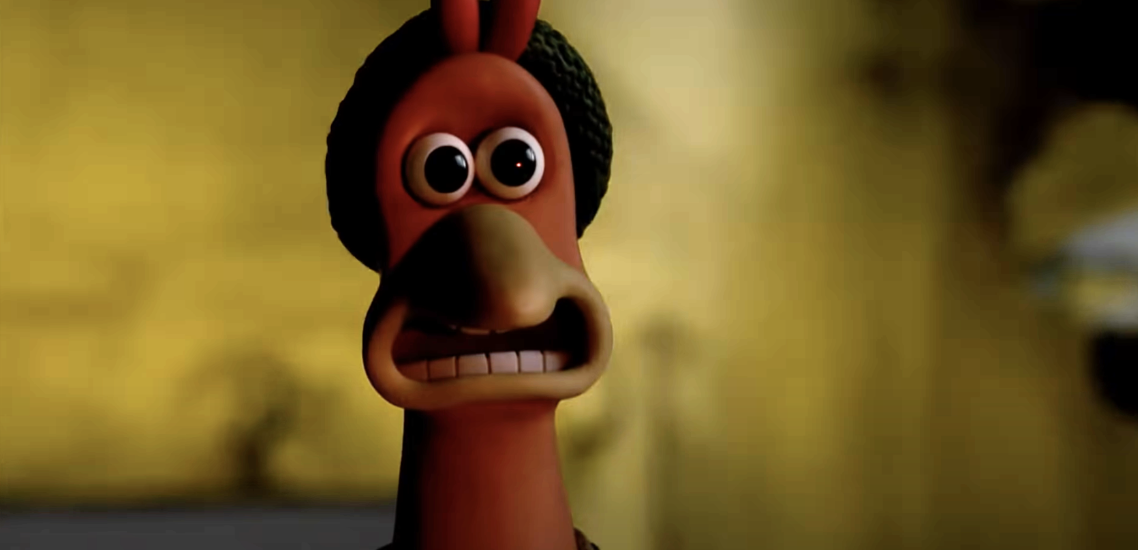 A claymation chicken looks terrified