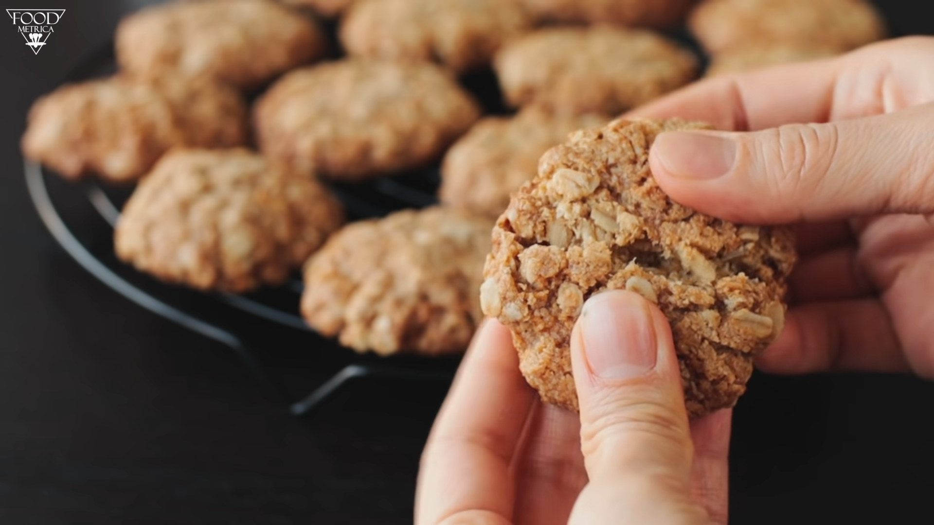 holding an oatmeal cookie