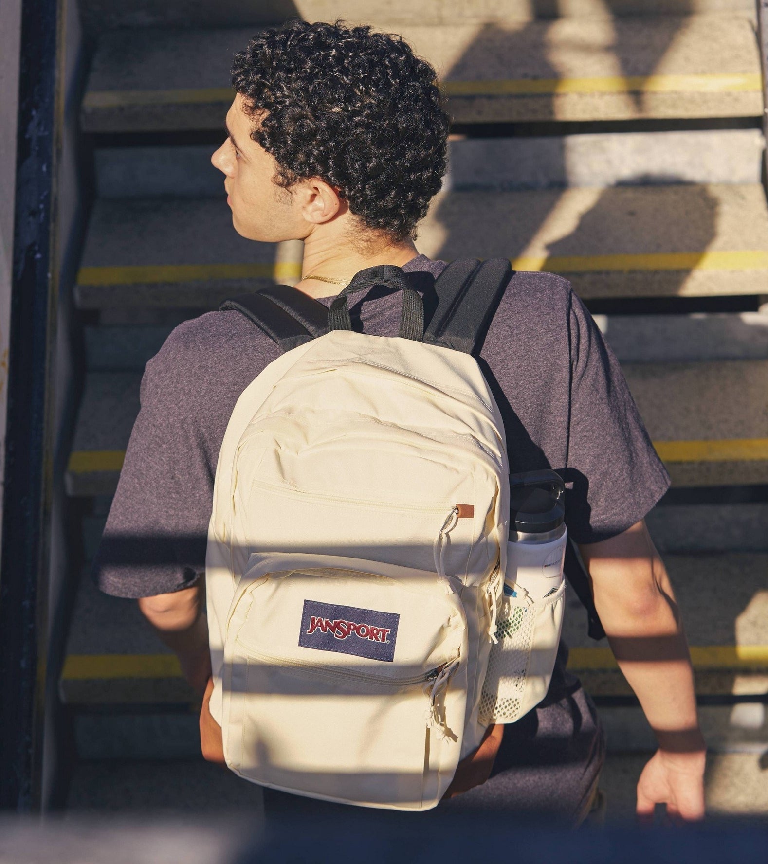 a model wearing the white backpack