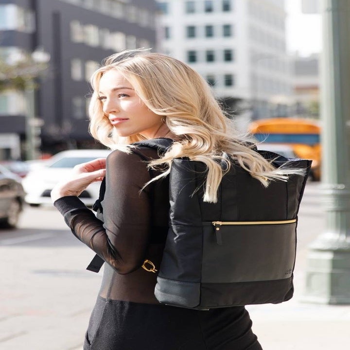 a model wearing the black backpack