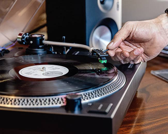 Model placing needle on record