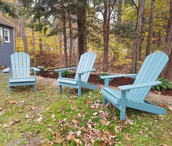 three reviewer's chairs in blue in a reviewer's yard
