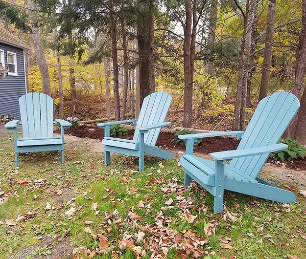 a set of three light blue adirondack chairs outdoors