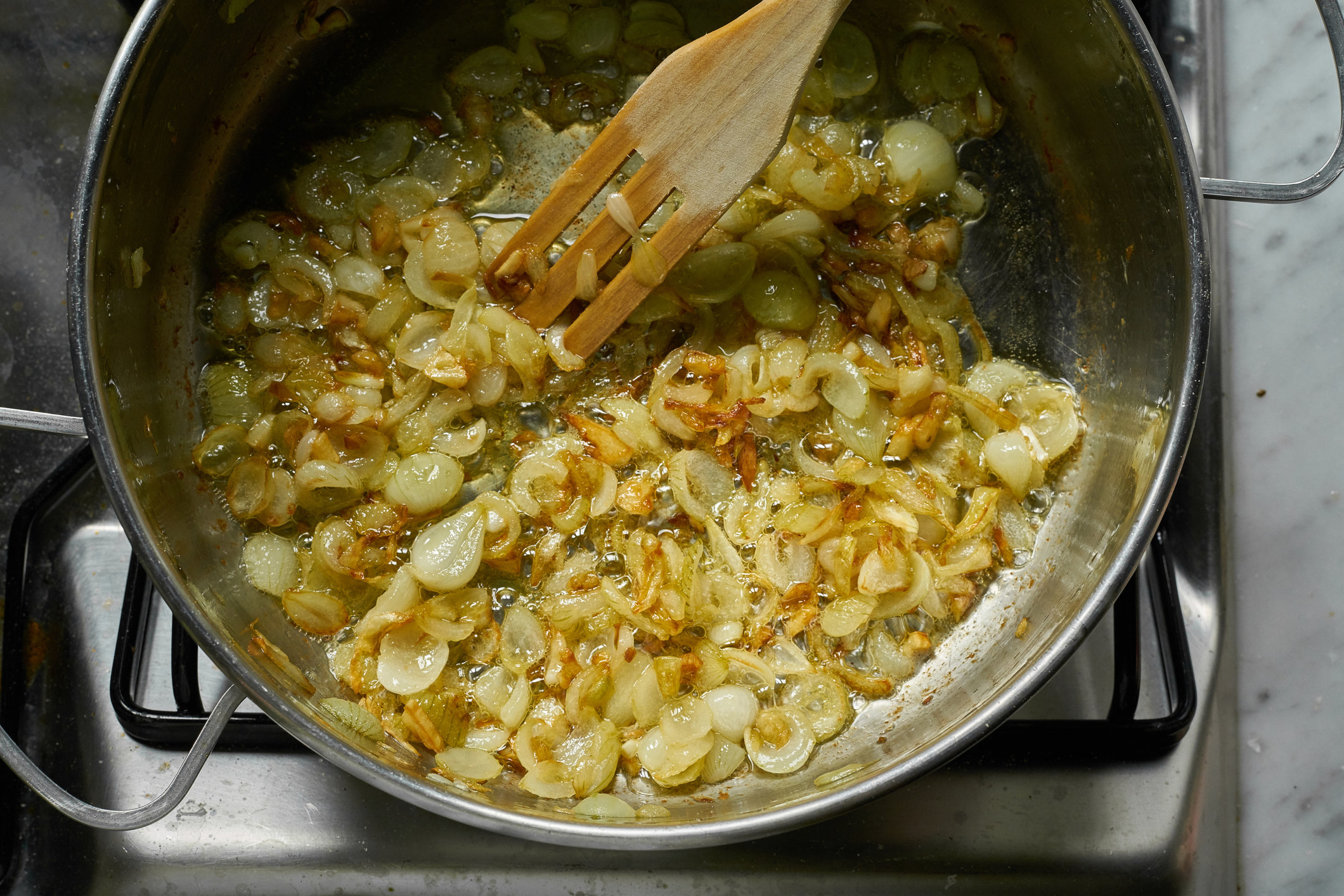 Golden sauteed onions in a pan