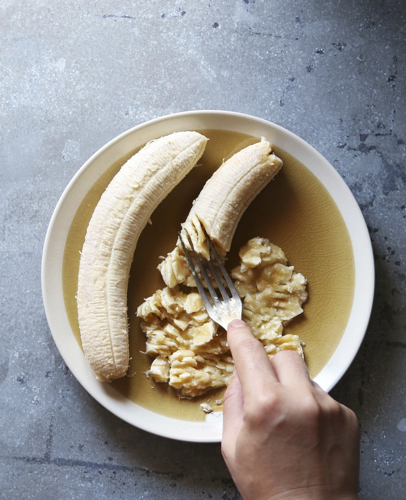 Mashing banana in a bowl