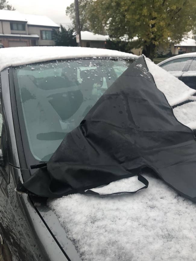 reviewer image of the windshield cover on a car covered in snow