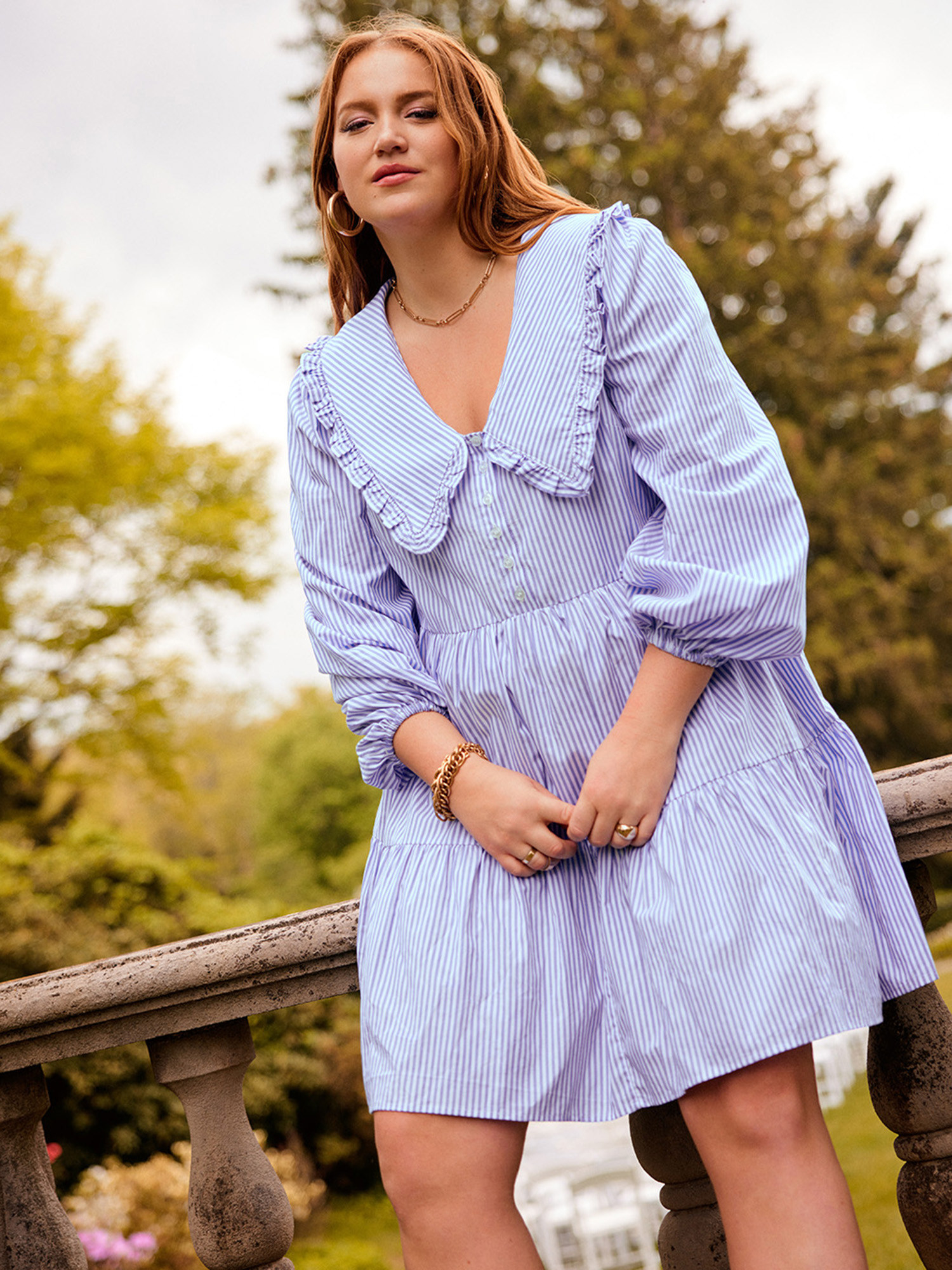 A model wearing a blue and white dress