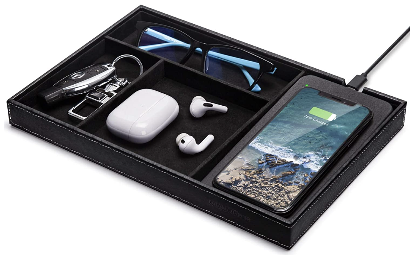 the nightstand organizer tray holding car keys, glasses, airpods, and a phone