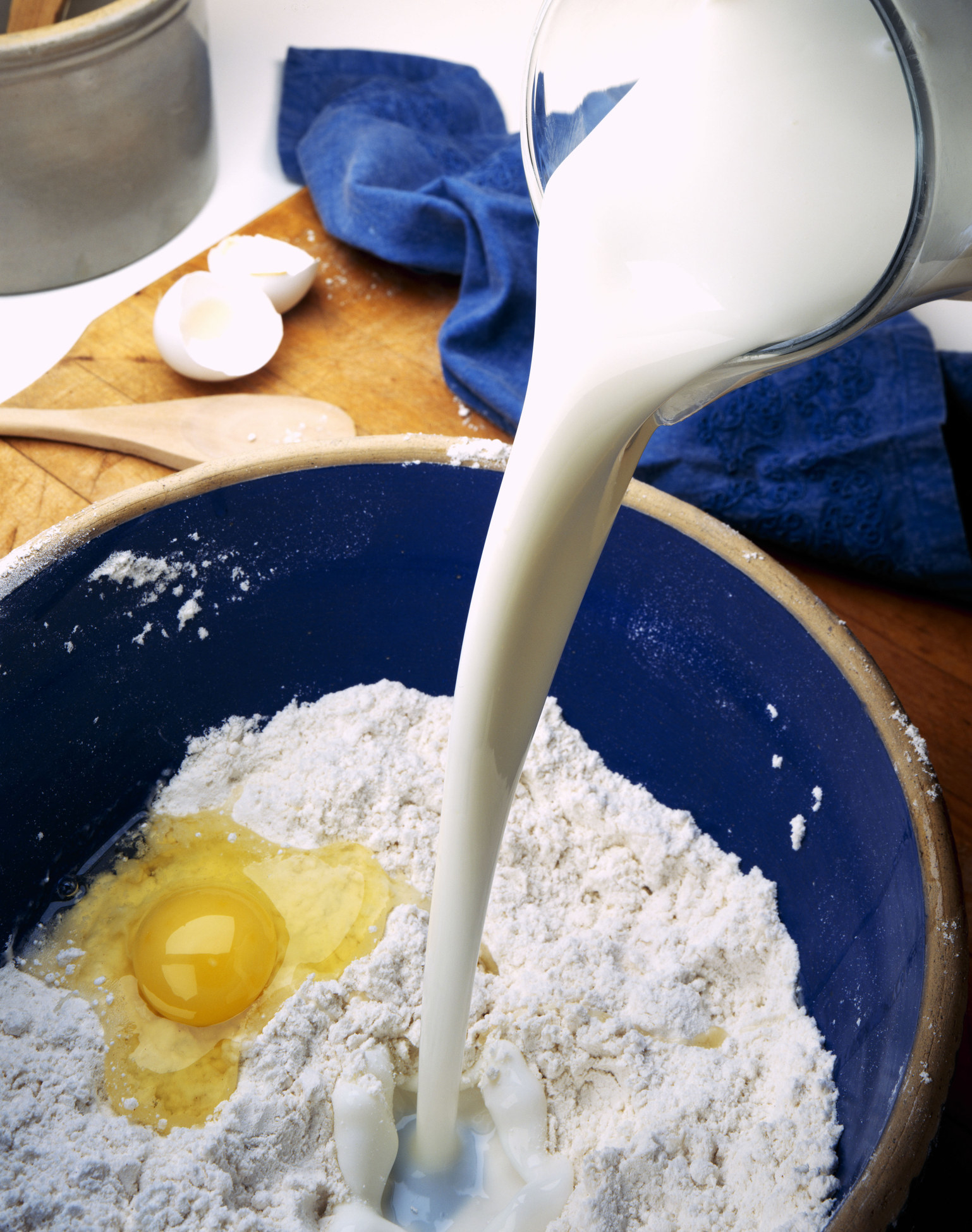 Pouring buttermilk into flour and egg