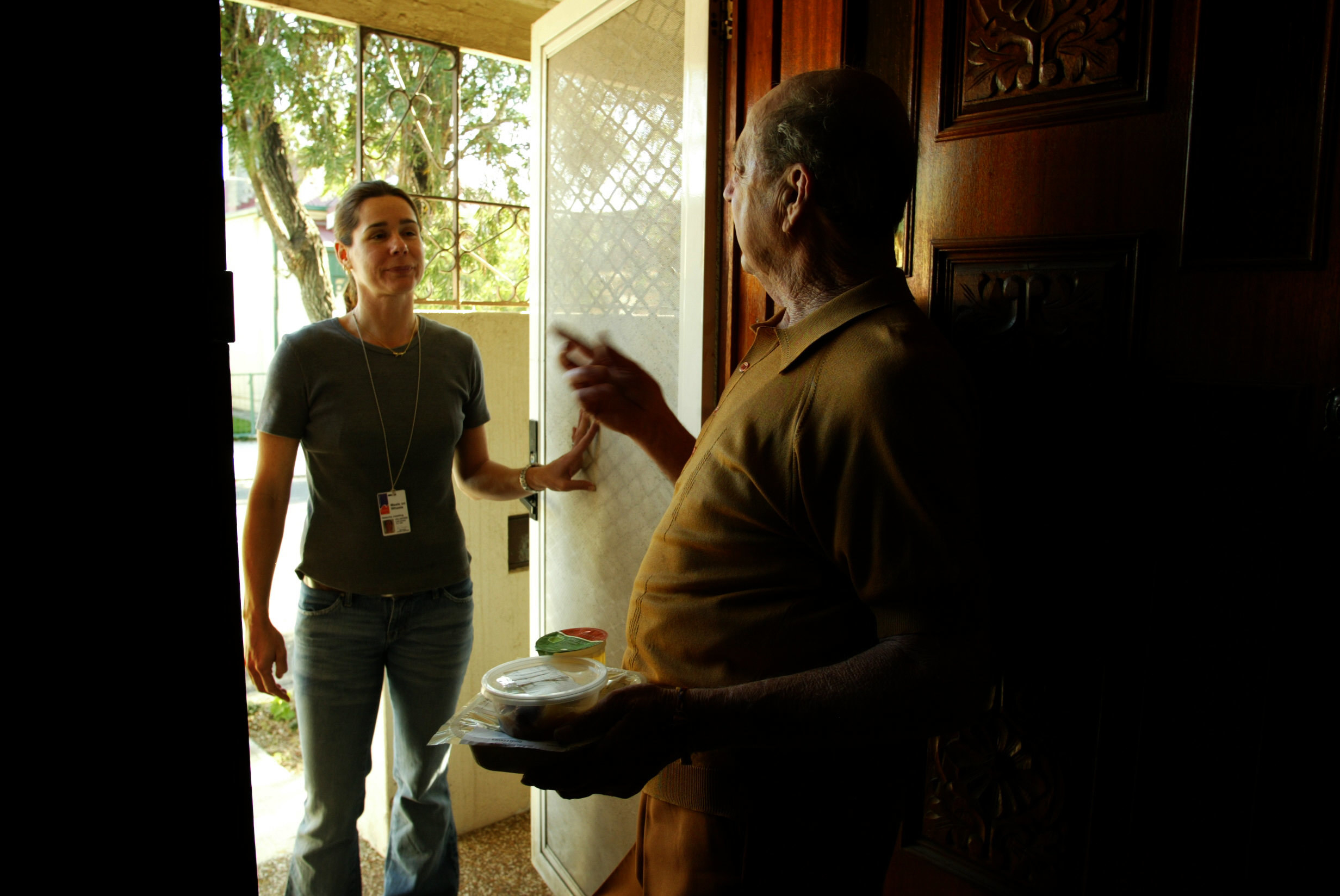 (AUSTRALIA OUT) Meals on Wheels volunteer Natacha Joesting delivers a meal to St Peters resident Harold Farmer on 25 August 2004.
