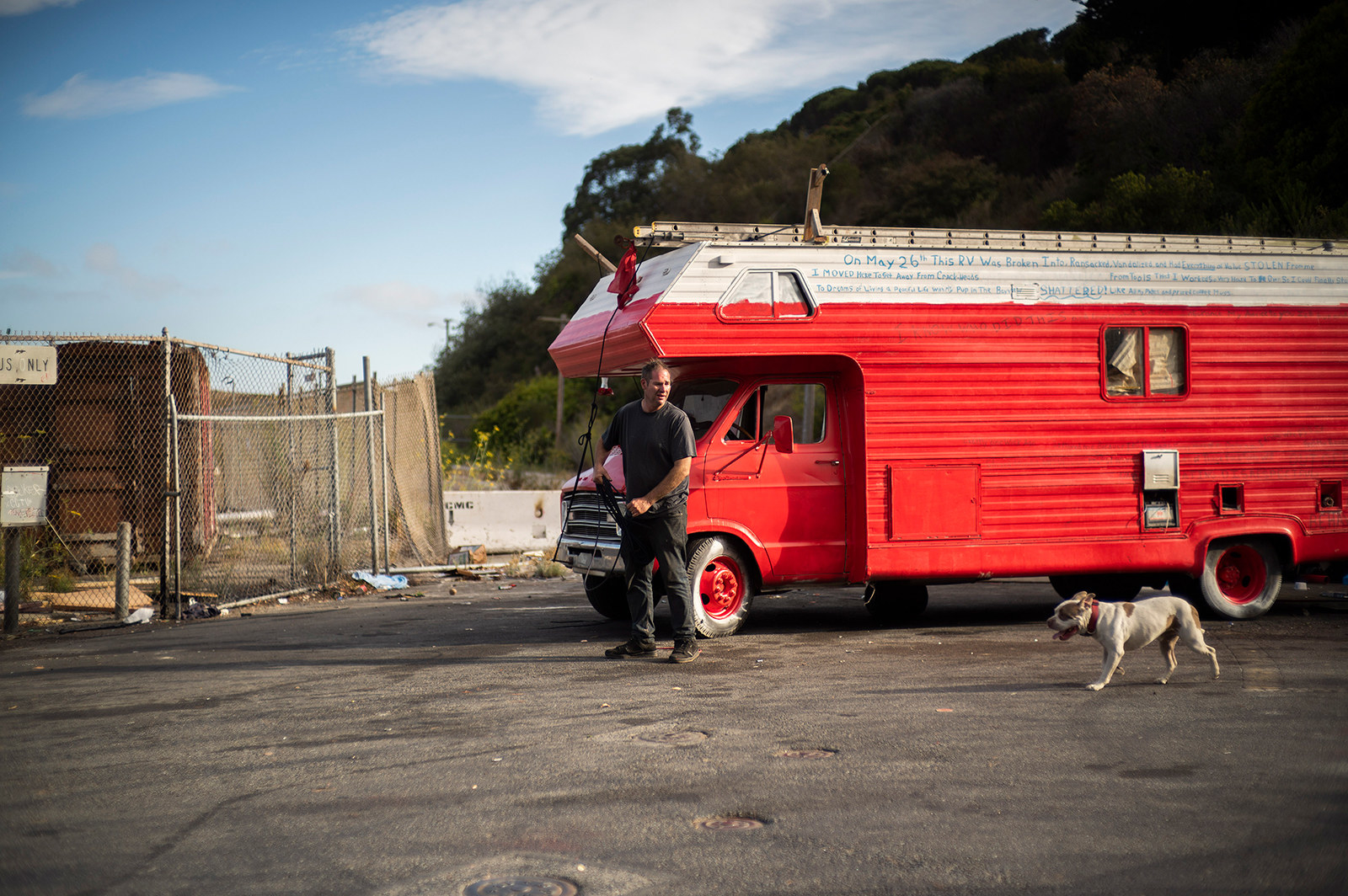 Smith stands in front of his RV with his dog