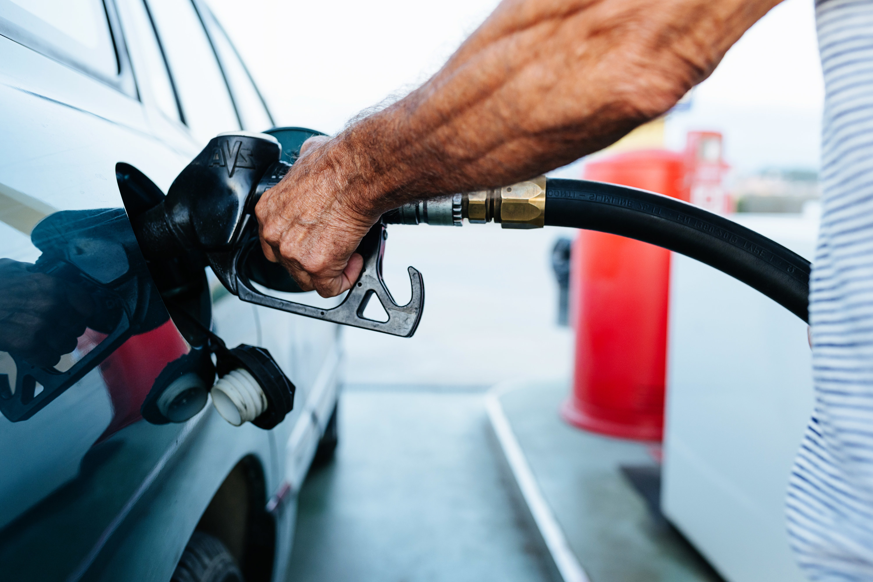 a person putting gas in their car