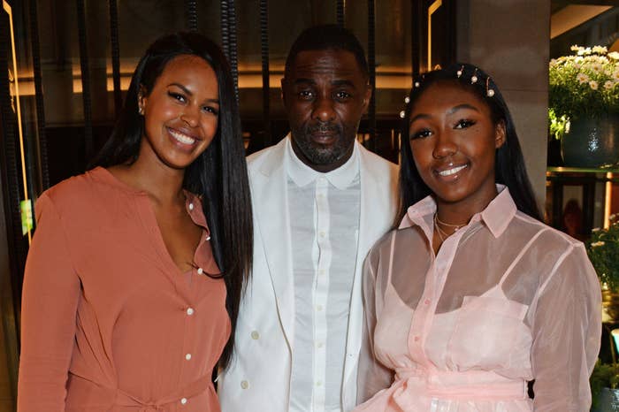 Idris poses for a photo with Isan and his wife, Sabrina