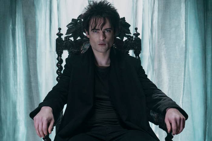 tom sturridge as the sandman sitting on a throne