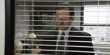 Gif of Michael Scott looking through blinds