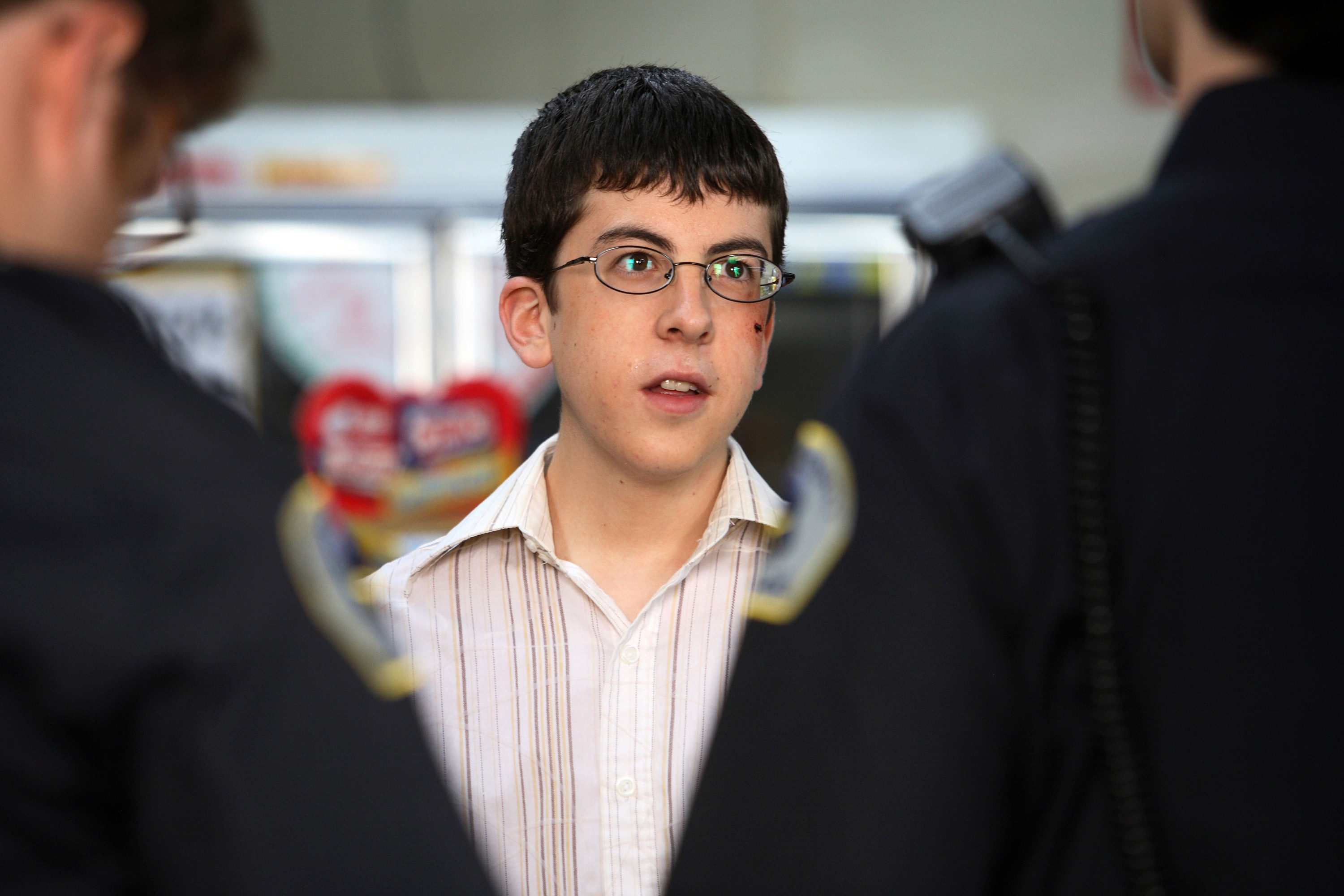 Christopher stands in front of cops in the movie