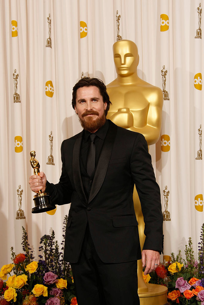 Christian Bale holding his Oscar