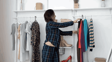 Woman throwing clothing out of closet