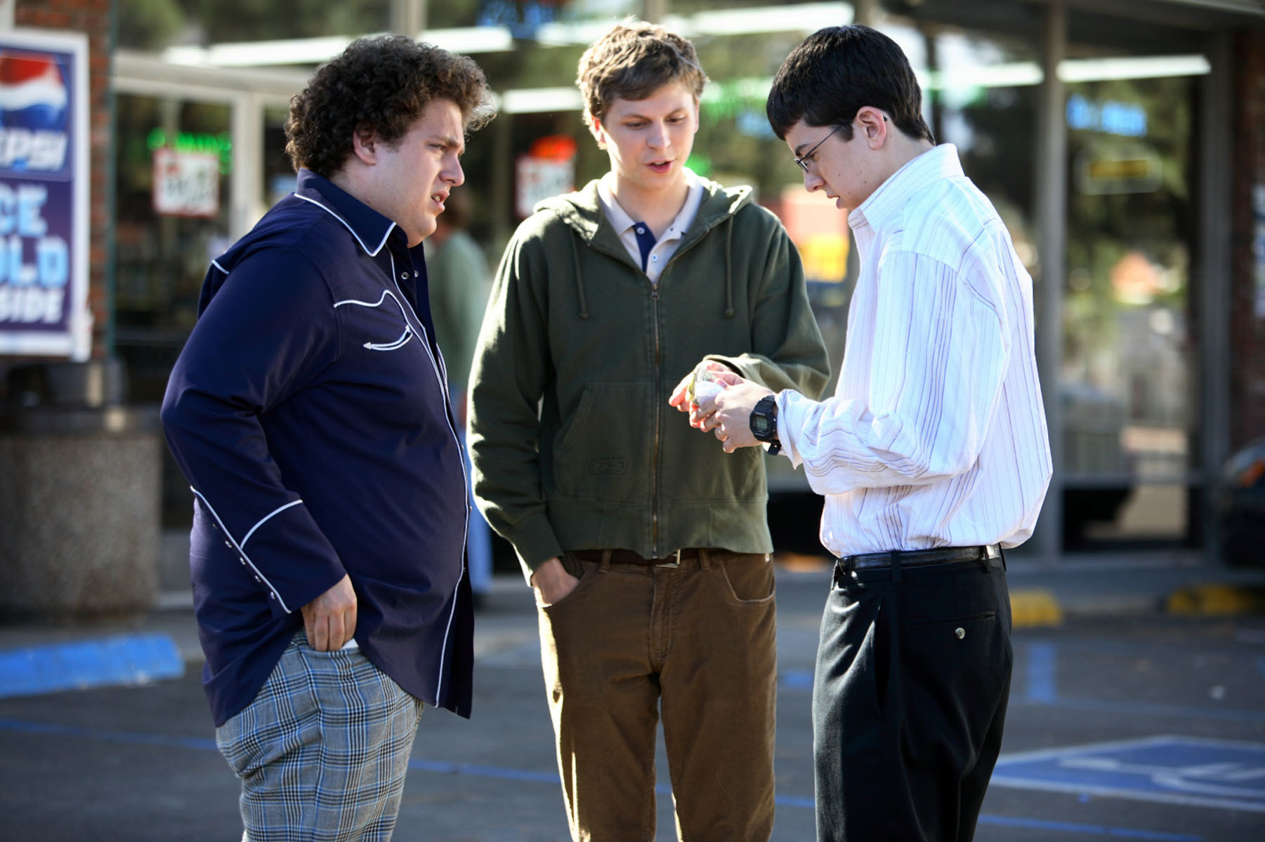 Jonah, Christopher and Michael stand outside a liquor store in the movie