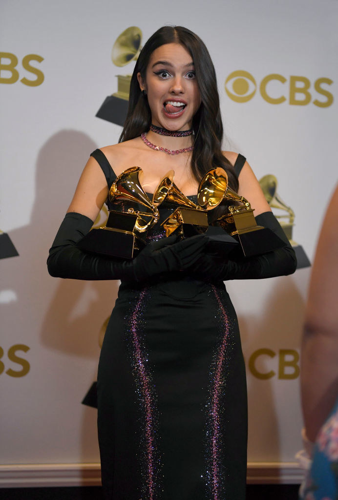 Olivia Rodrigo holding her Grammys