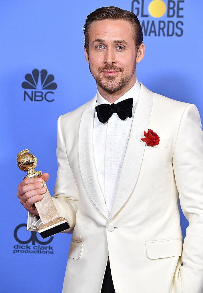 Ryan Gosling holding a Golden Globe