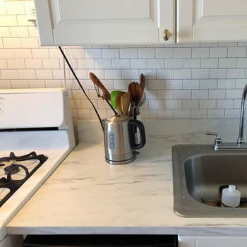 the white subway tile on the wall of a kitchen