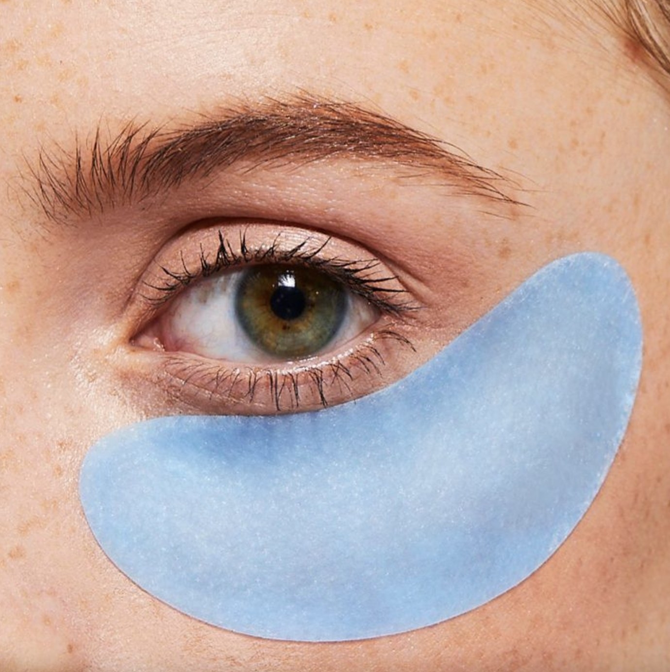 A person wearing a blue eye mask