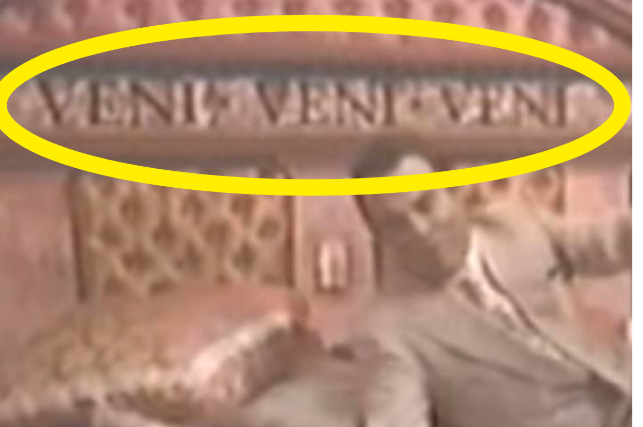 Two people falling onto a bed with a headboard that says veni veni veni