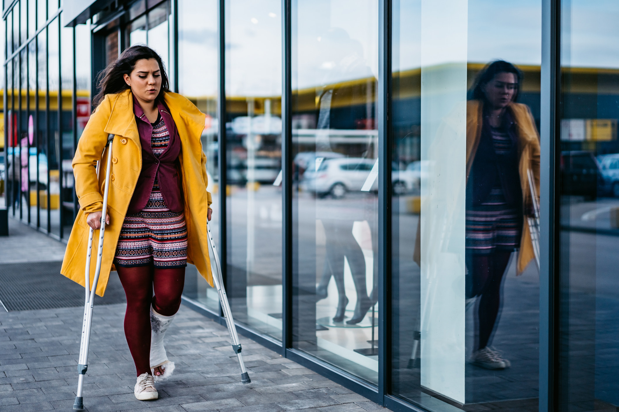 Woman walking while using crutches
