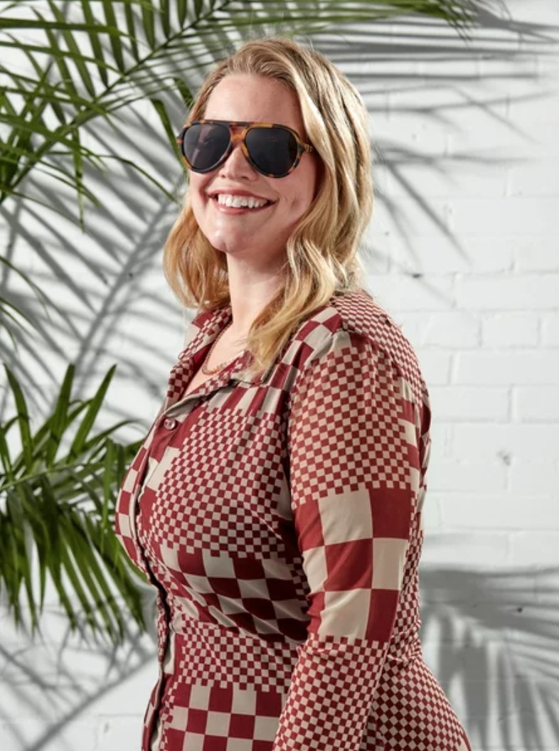 A model in tortoise shell aviators and a red checkered top