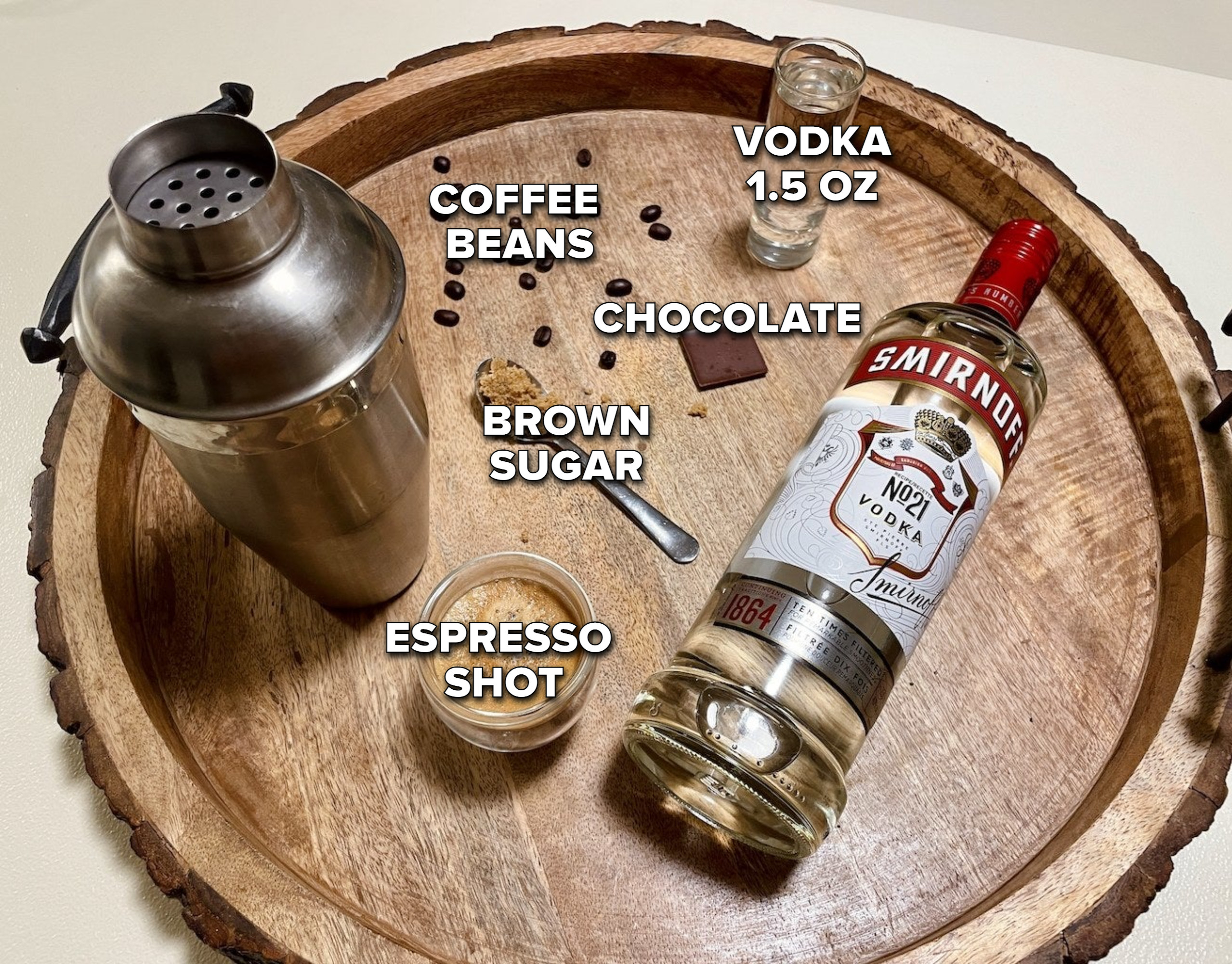 a shot of espresso, a shaker, brown sugar, coffee beans, chocolate, and vodka