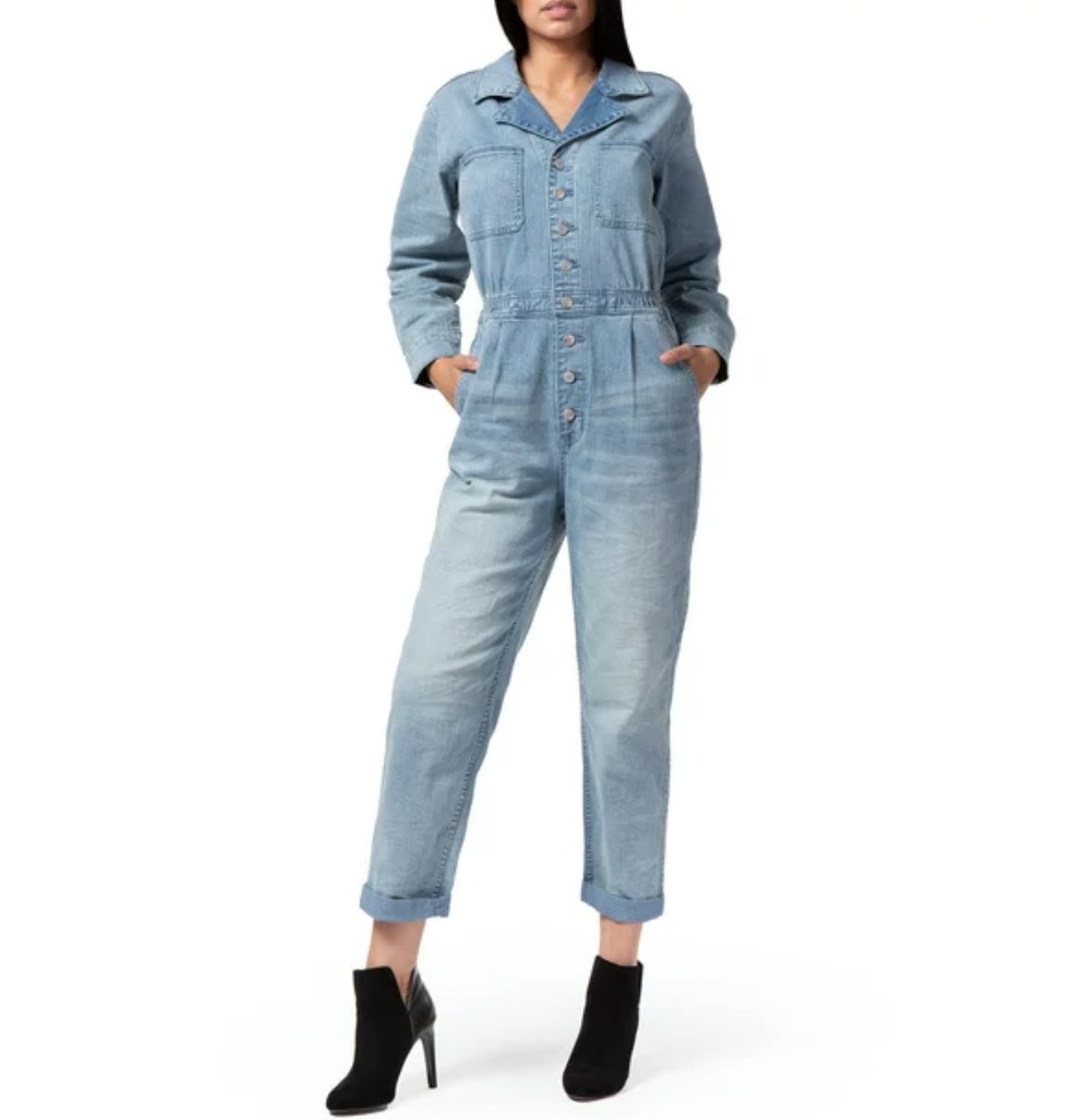 A model in a denim jumpsuit and black booties