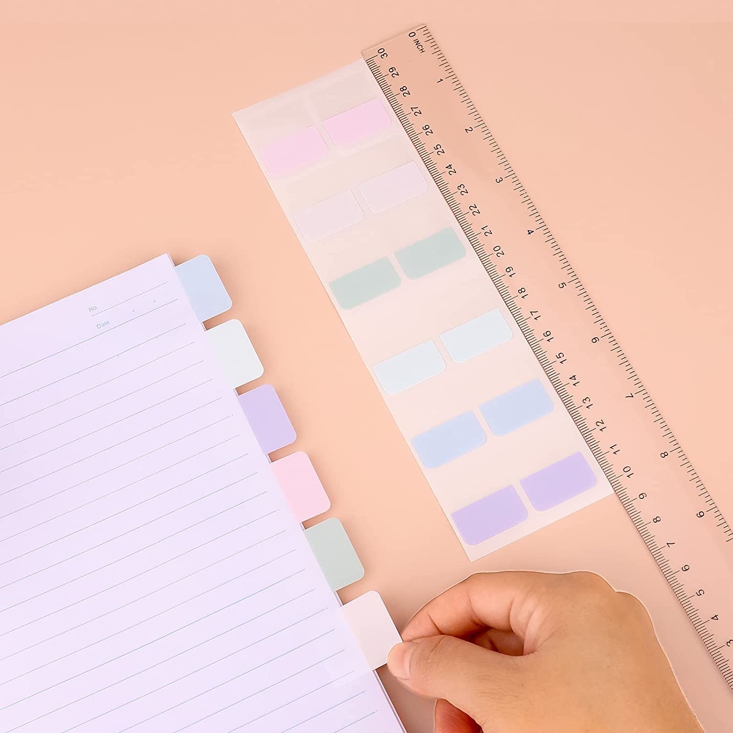 A hand putting sticky tabs on paper