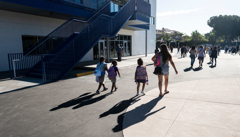 A teacher walking with students