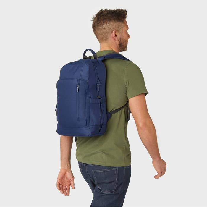 a model wearing the blue backpack