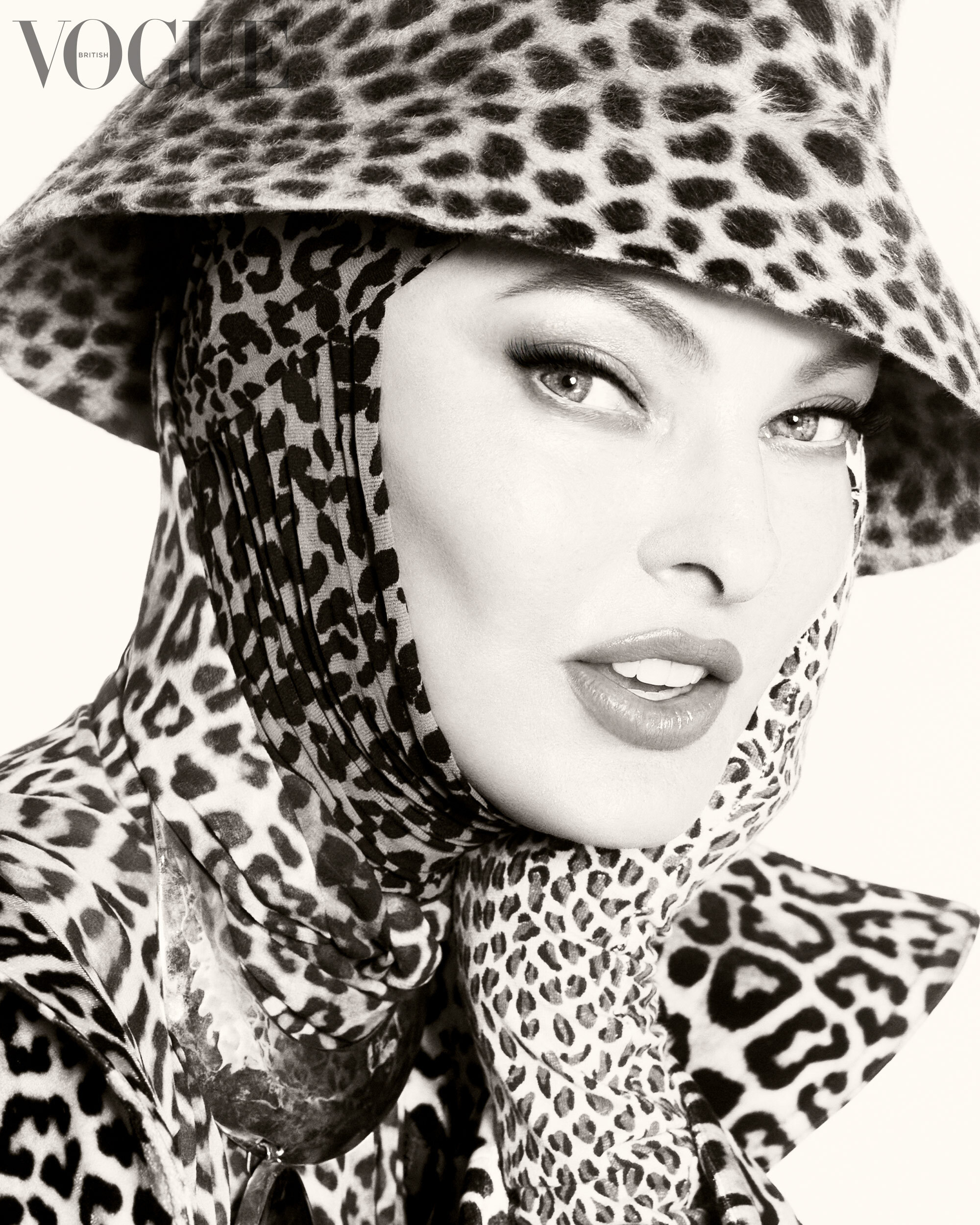 Linda wearing animal print hat, scarf, and jacket in Vogue spread