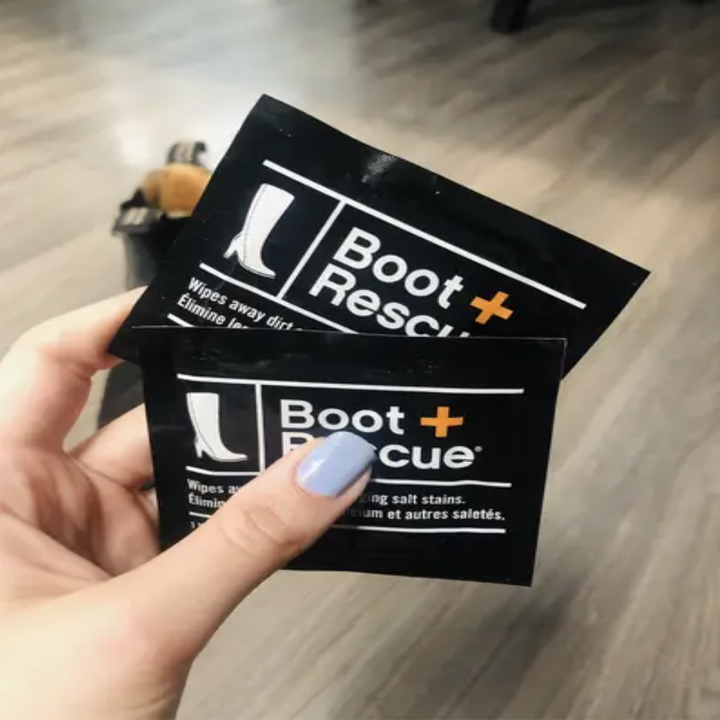 Alice holding two boot-cleaning cloths