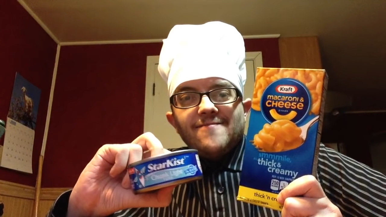 home chef holding canned tuna and boxed mac n cheese