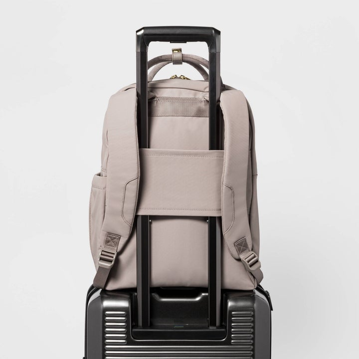 the taupe backpack on a luggage