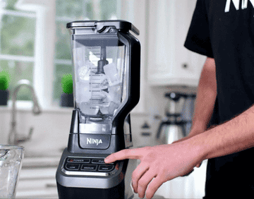 a gif of a person blending ice in the blender