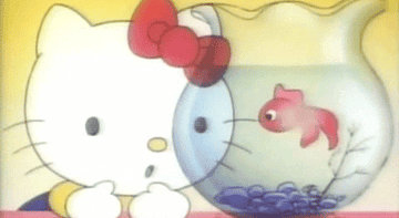 Hello Kitty looking at a fish bowl