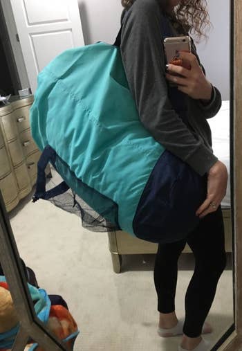 Reviewer wearing the blue backpack laundry bag
