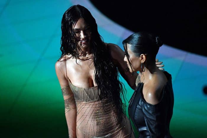 Kourtney and Megan smile while on stage together