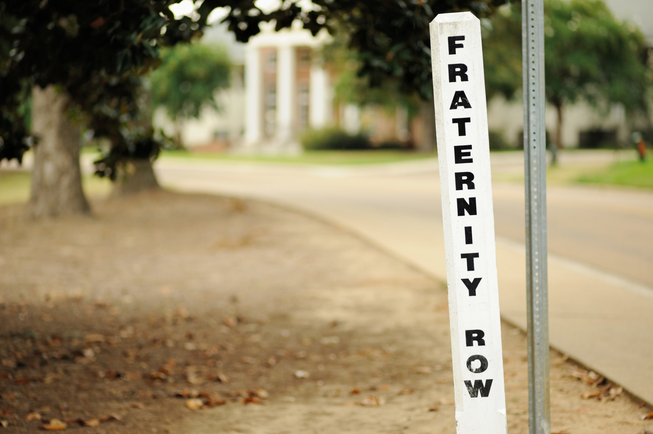 a sign in the ground that reads &quot;fraternity row&quot;