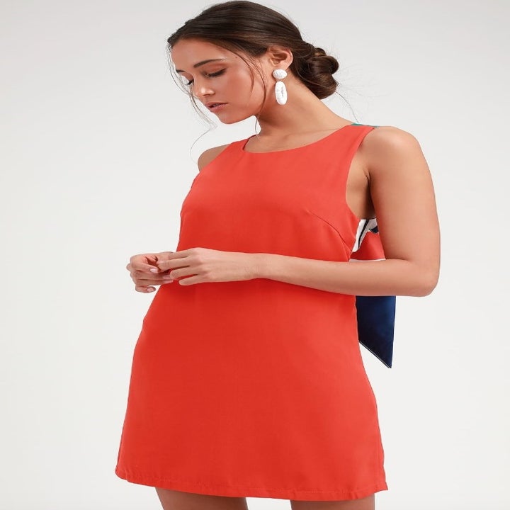 Model wearing red sleeveless mini dress