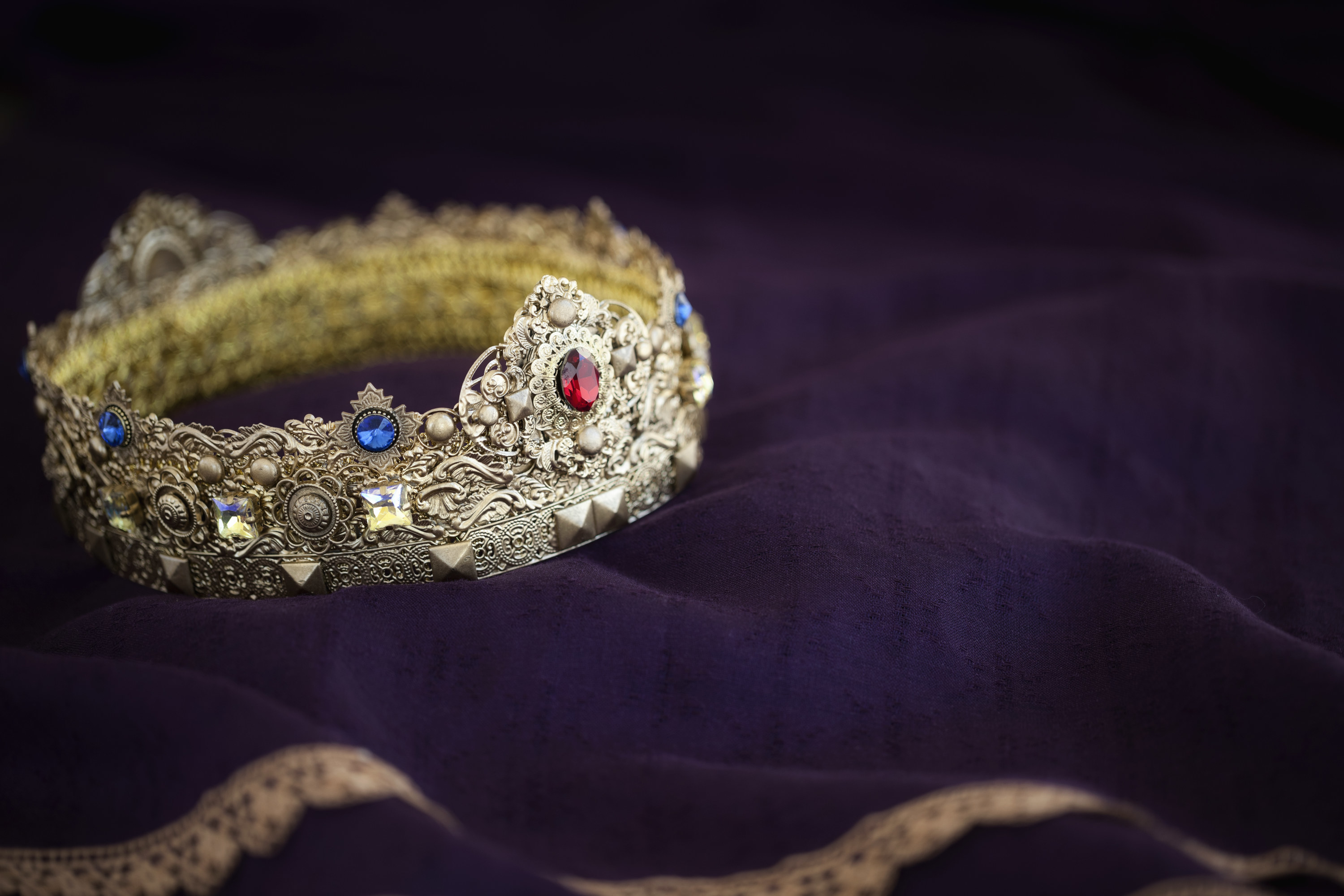 A golden crown with multi-colored jewels