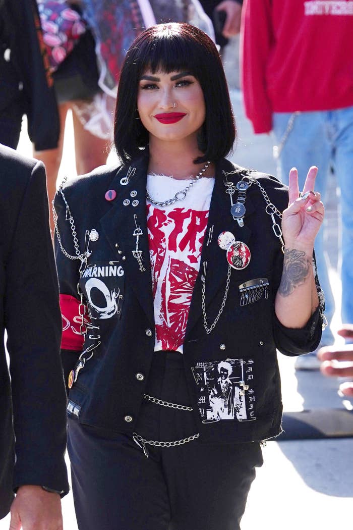Closeup of Demi Lovato giving the peace sign